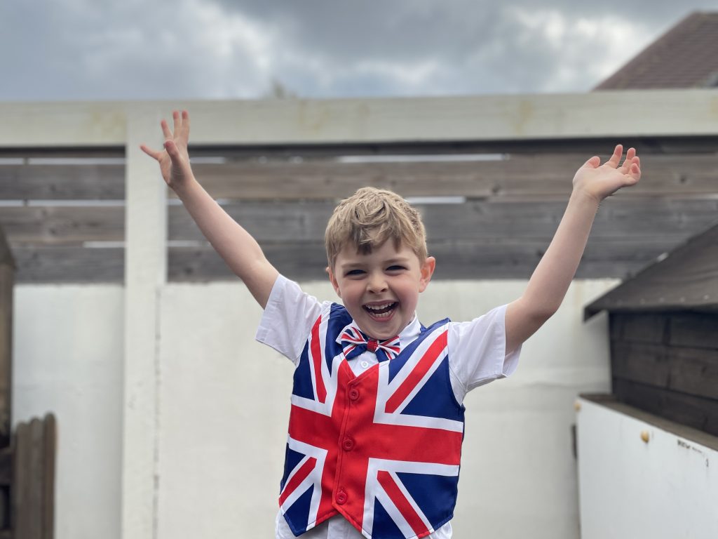 student with his arms in the air